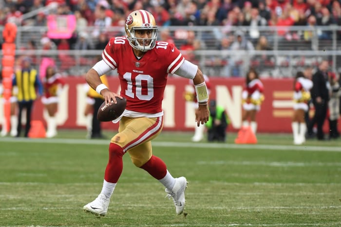 Jimmy Garoppolo scrambling with the football.