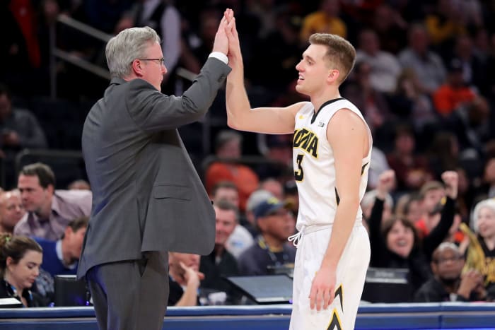 Jordan Bohannon high-fives Iowa basketball coach Fran McCaffrey.