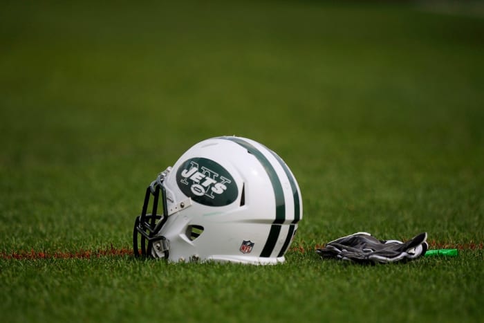 A New York Jets helmet sitting on the field.