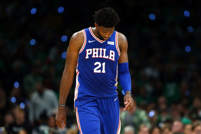 Joel Embiid with his head down during a game.