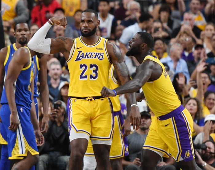 lebron james flexes during a preseason game