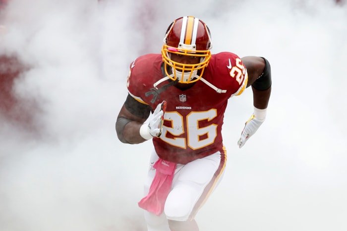 Adrian Peterson running onto the field prior to a Redskins game.