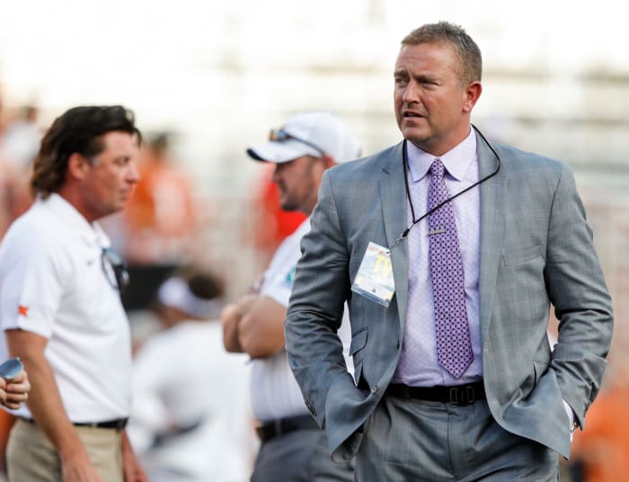 Kirk Herbstreit walks on the field before the college football game between Texas and Oklahoma State.