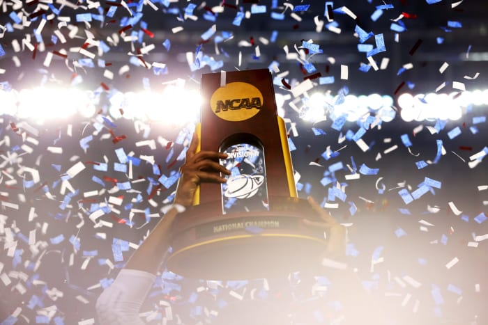 The UConn Huskies holding up the National Championship trophy.