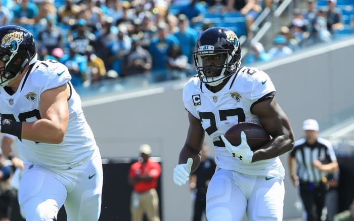 Leonard Fournette runs with the football against the New York Jets.