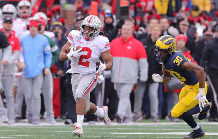 J.K. Dobbins runs away from a Michigan defender.