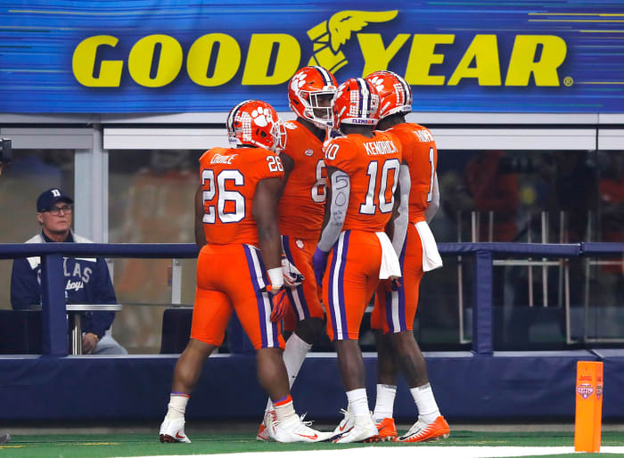 Justyn Ross celebrates with Clemson teammates including Derion Kendrick after touchdown.
