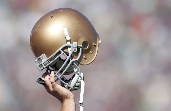 A closeup of a notre dame player's helmet.
