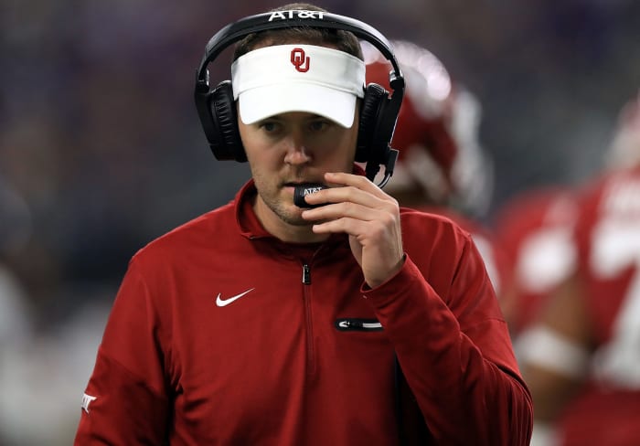 A closeup of Oklahoma Sooners coach Lincoln Riley talking into his headset.