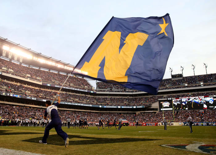 A Naval Academy cheerleader waving a flag during the Army-Navy Game in 2015.