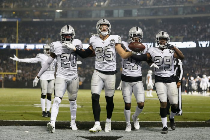 Raiders players Erik Harris, Daryl Worley celebrate interception.