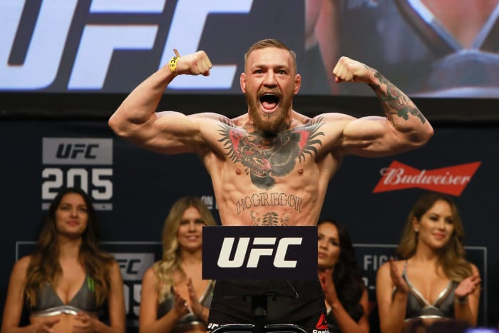 Conor McGregor flexing his biceps.