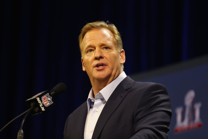 NFL commissioner Roger Goodell talking at a podium at the Super Bowl.