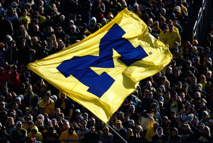 Fans watch a Michigan Wolverines flag after a score against the Illinois Fighting Illini.
