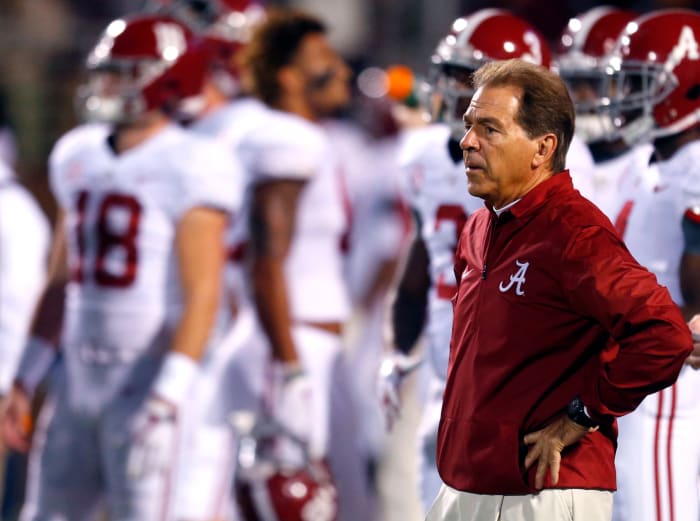 Head coach Nick Saban of the Alabama Crimson Tide watches the team warm up before the first half of an NCAA football game against the Mississippi State Bulldogs.