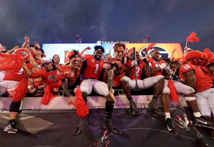 Georgia football players interacting with fans.