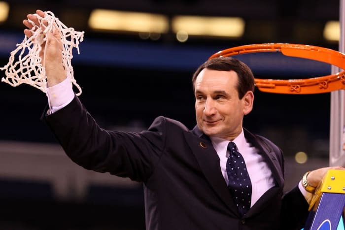 Coach K cuts down the net.