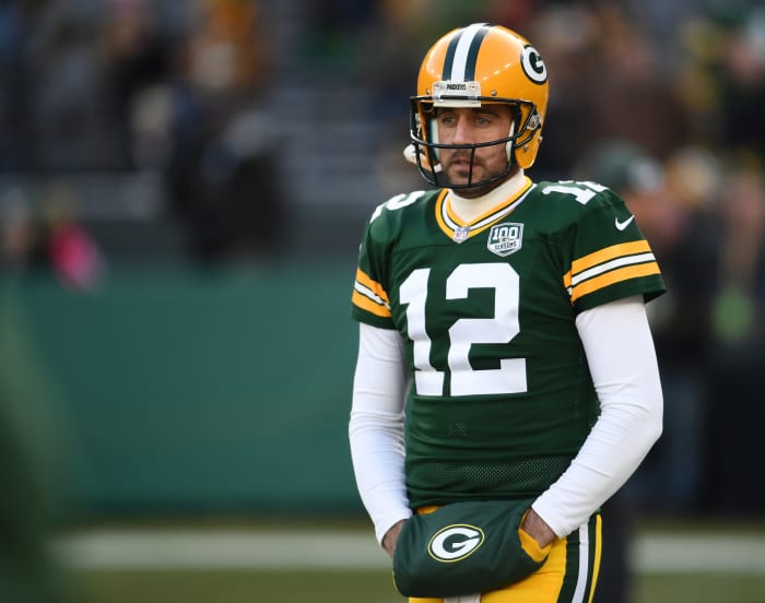 Green Bay Packers QB Aaron Rodgers with his hands in a hand warmer.
