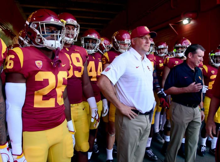 Clay Helton standing with his USC football players in the tunnel before a game.