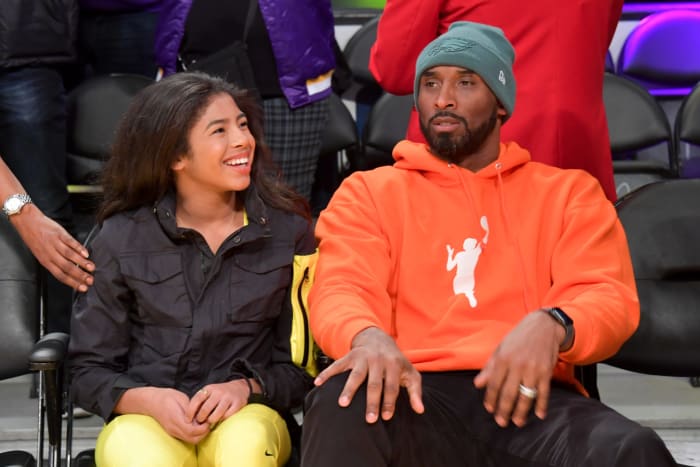 Kobe Bryant and his daughter Gianna watch an NBA game.