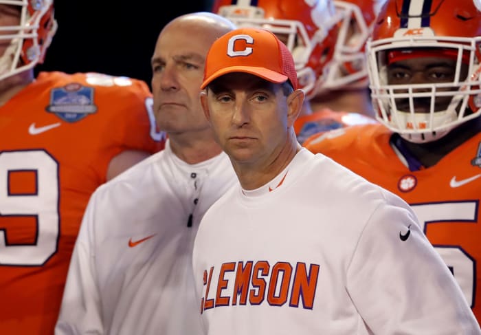 A closeup of Clemson head coach Dabo Swinney standing with his players.