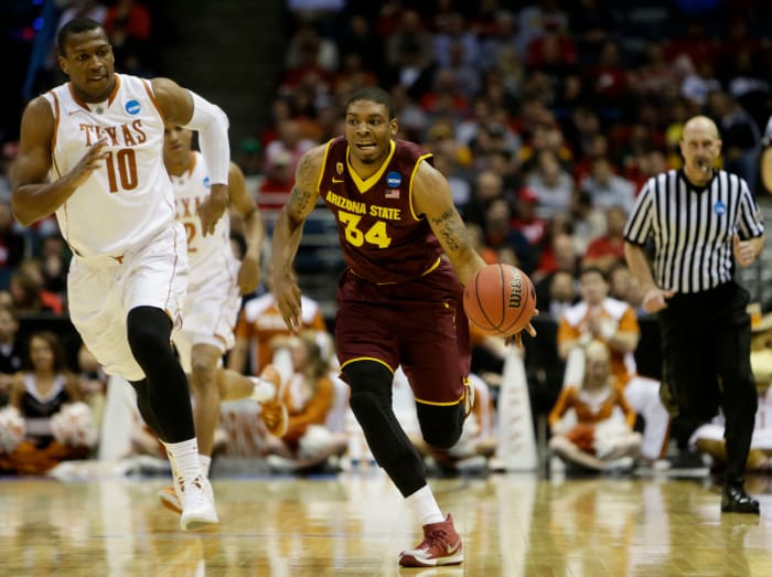 MILWAUKEE, WI - MARCH 20: Jermaine Marshall #34 of the Arizona State Sun Devils controls the ball against Jonathan Holmes #10 of the Texas Longhorns in the second half during the second round of the 2014 NCAA Men's Basketball Tournament at BMO Harris Bradley Center on March 20, 2014 in Milwaukee, Wisconsin. (Photo by Mike McGinnis/Getty Images)