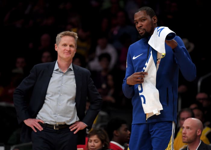 Steve Kerr stands alongside Kevin Durant.