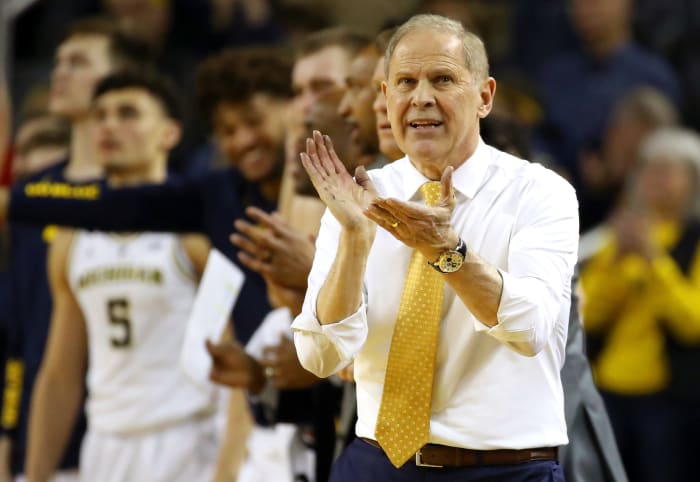 Michigan basketball head coach John Beilein clapping during a game.
