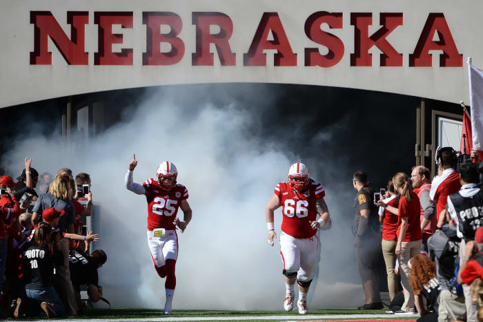 Nebraska football player Nathan Gerry runs onto the field.