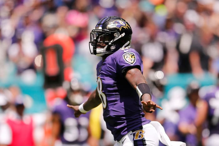 Lamar Jackson throws a touchdown pass to Hollywood Brown during a Baltimore Ravens game.