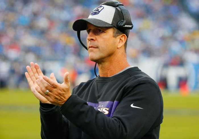 A closeup of Baltimore Ravens coach John Harbaugh clapping.