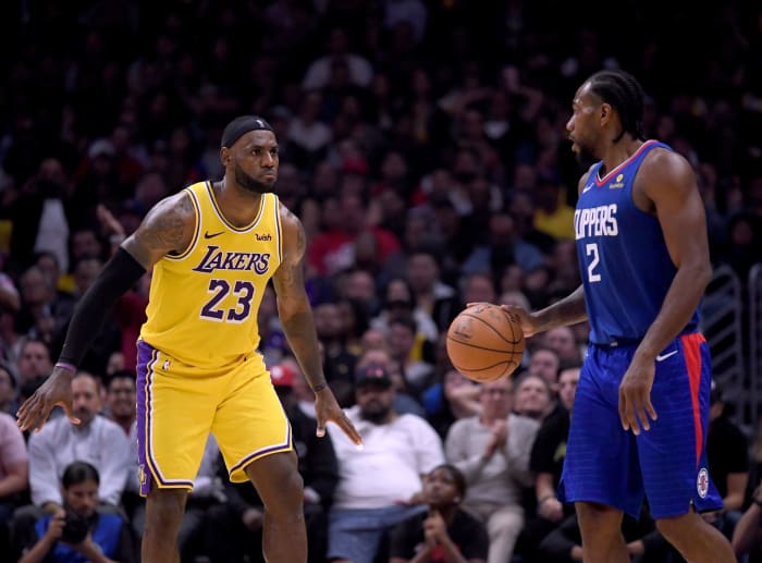 LeBron James guarding Kawhi Leonard during the season opener.