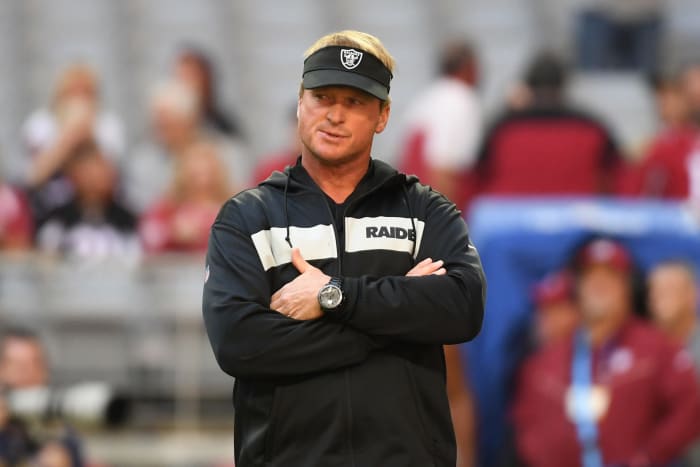 A closeup of Oakland Raiders coach Jon Gruden wearing a black visor.