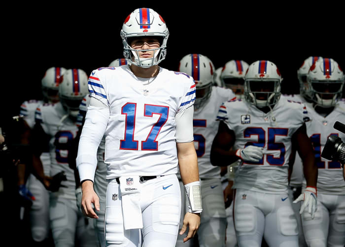 Josh Allen leading the Bills onto the field for an NFL game.