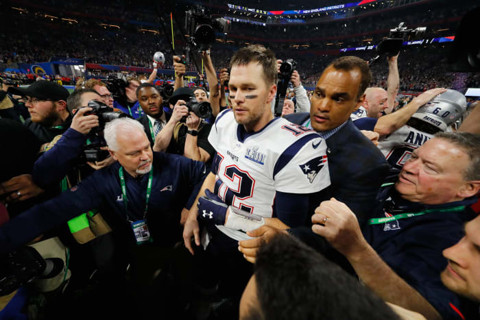 tom brady walks on the field after winning the super bowl