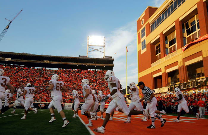 The Texas Longhorns football team running onto the field.