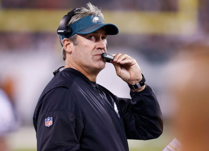 Doug Pedersen talking into a headset on the sideline.