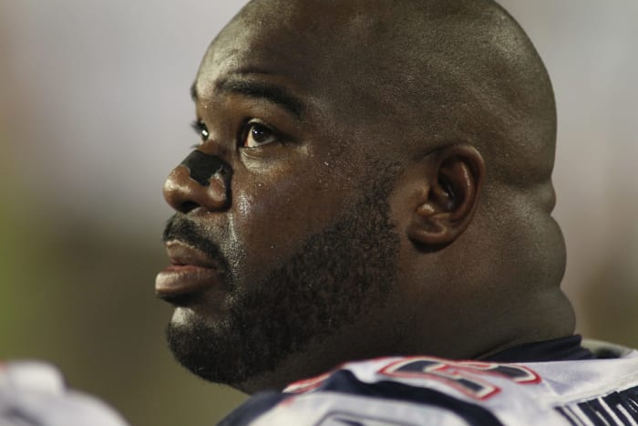Albert Haynesworth sits on the bench during an NFL game.