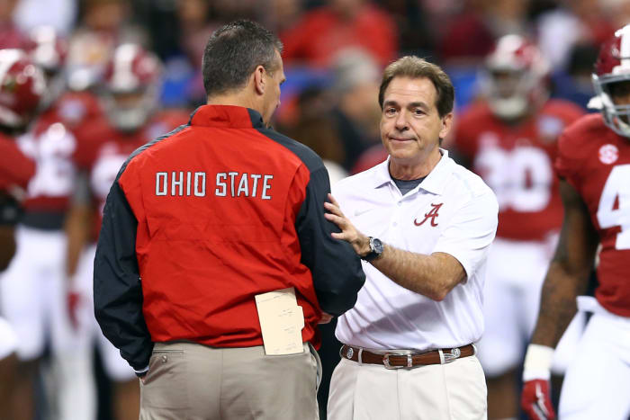 Head coach Urban Meyer of the Ohio State Buckeyes shakes hands with head coach Nick Saban of the Alabama Crimson Tide in an SEC vs. Big Ten football showdown.