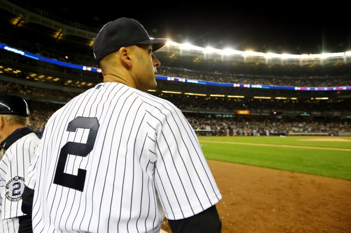 Derek Jeter watching from the Yankee dugout.