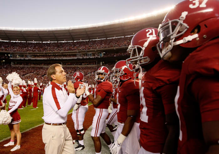 Head coach Nick Saban of the Alabama Crimson Tide leads his team on the field.
