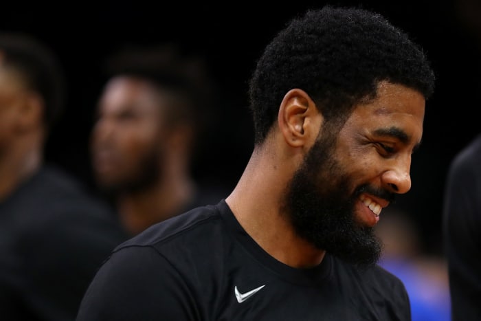 A closeup of a smiling Kyrie Irving.