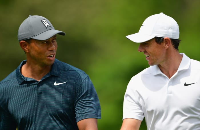 Tiger Woods and Rory McIlroy walk the course.