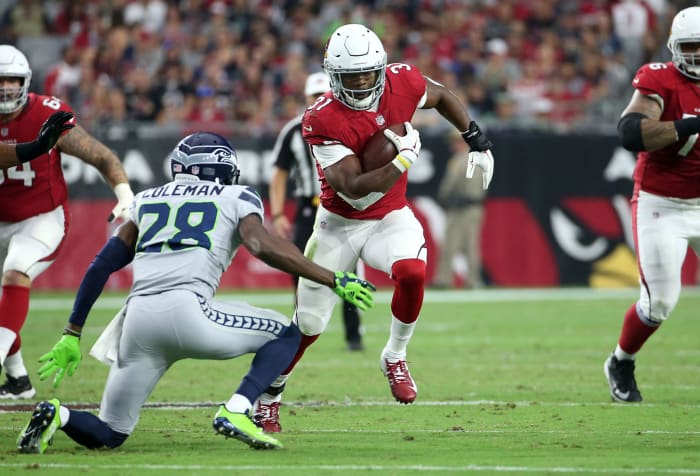 David Johnson running with the football.