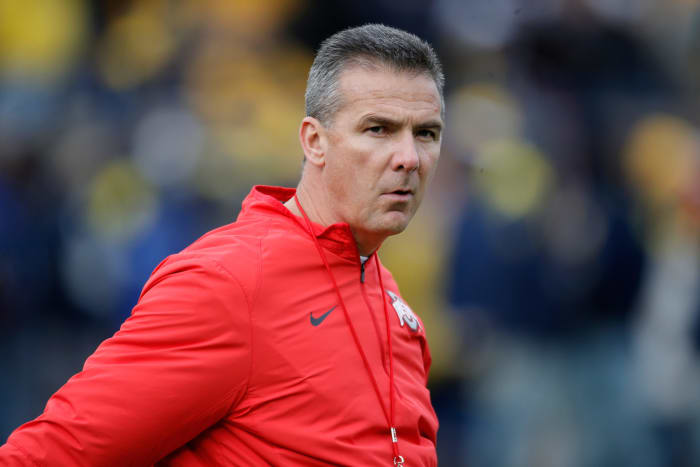 A closeup of Urban Meyer wearing an Ohio State windbreaker.