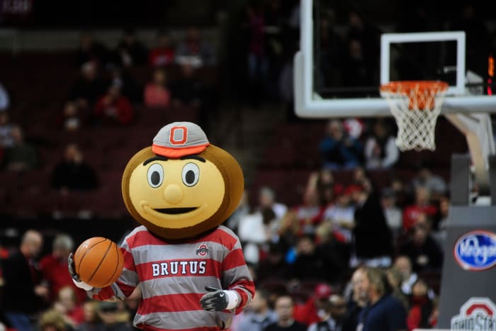 A closeup of Ohio State's mascot dribbling a basketball.