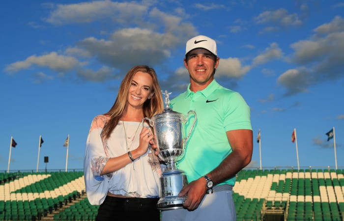 Brooks Koepka holding a trophy.