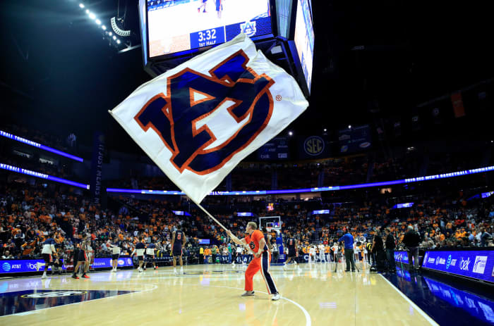 An Auburn Tigers cheerleader waving a flag.