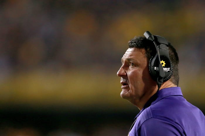 Ed Orgeron wearing a headset looking worried.