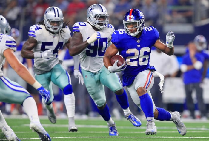 Saquon Barkley running the football.